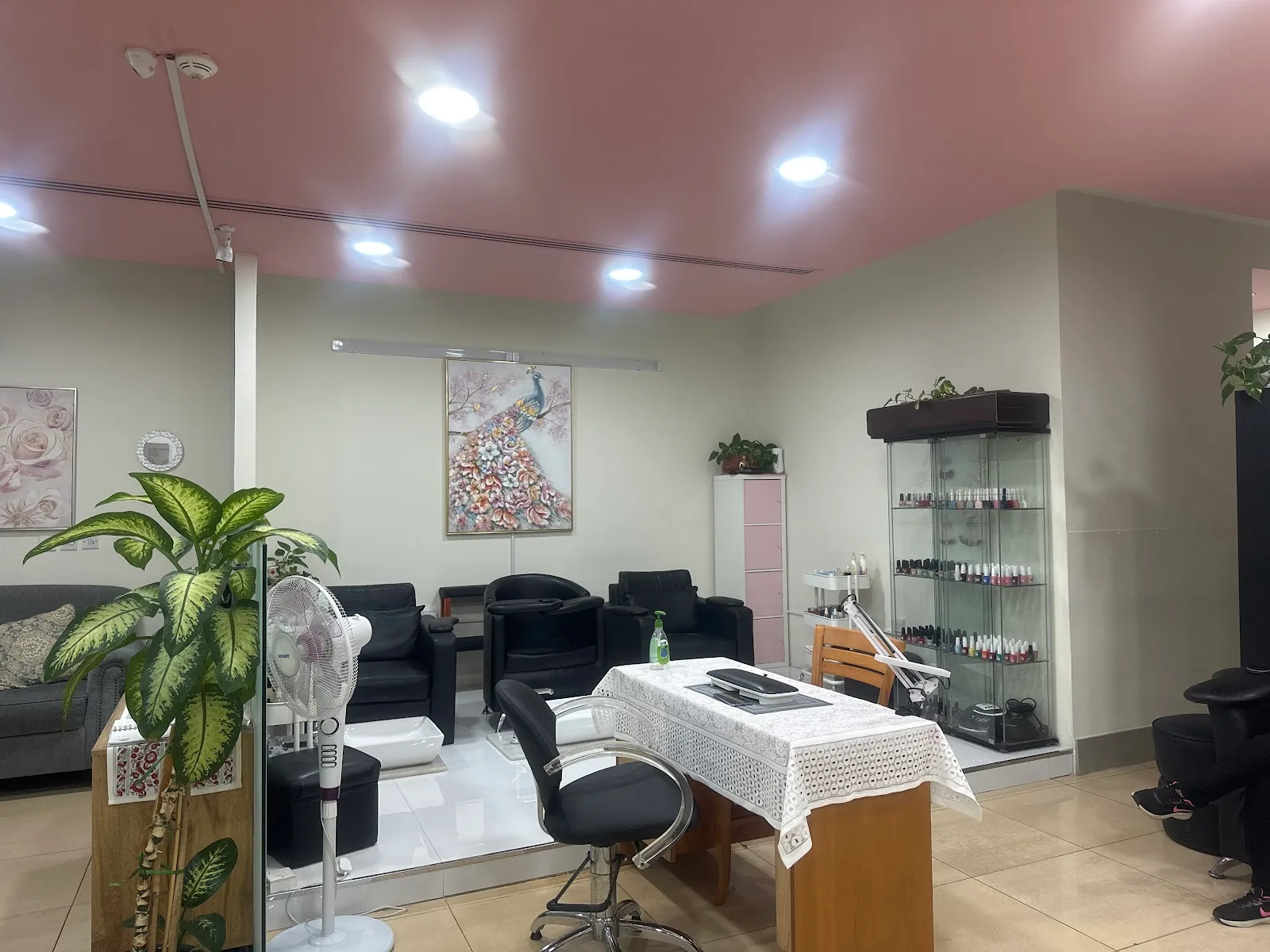 The salon lounge with manicure station and nail polish wall