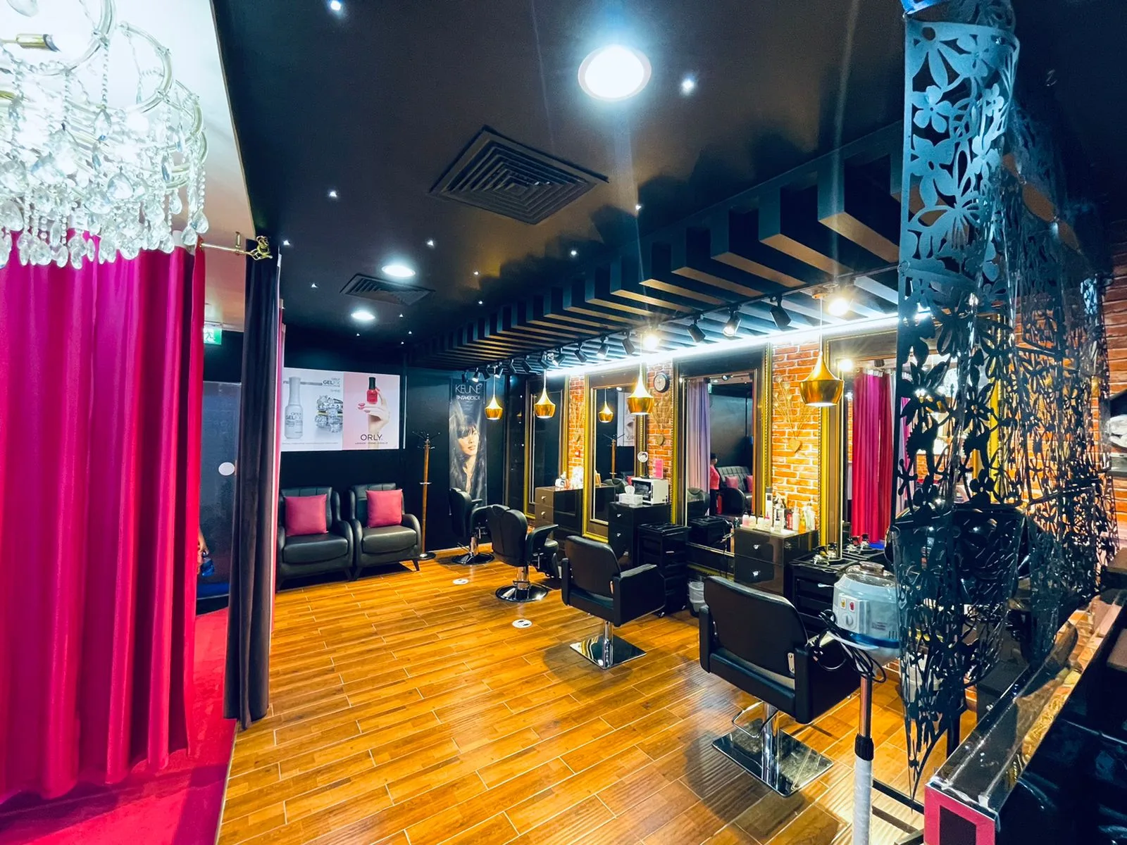 Inside Pink Blink The Beauty Lounge — chandeliers, gold-framed mirrors and brick-walled styling stations