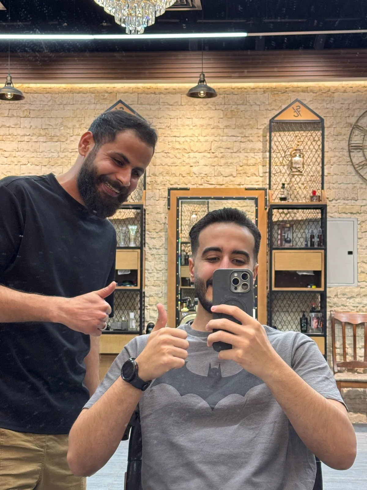 Two happy clients giving a thumbs up after their cut at Shave Cave