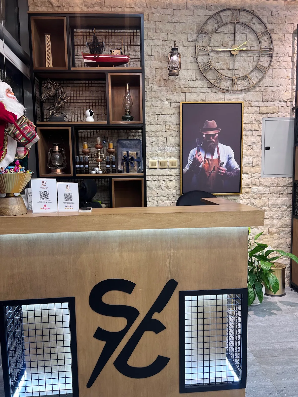 Shave Cave reception desk with the gold SC monogram and a vintage shelf display