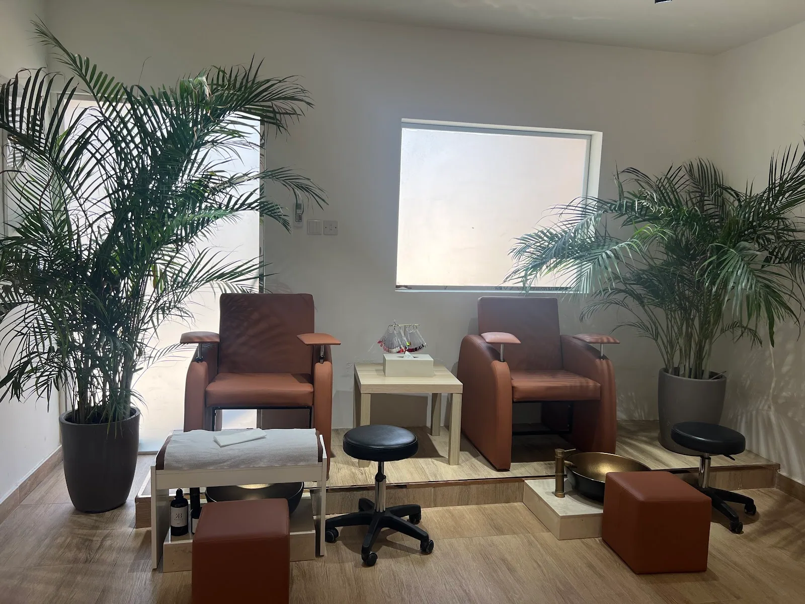 Calm treatment room with terracotta chairs and palms