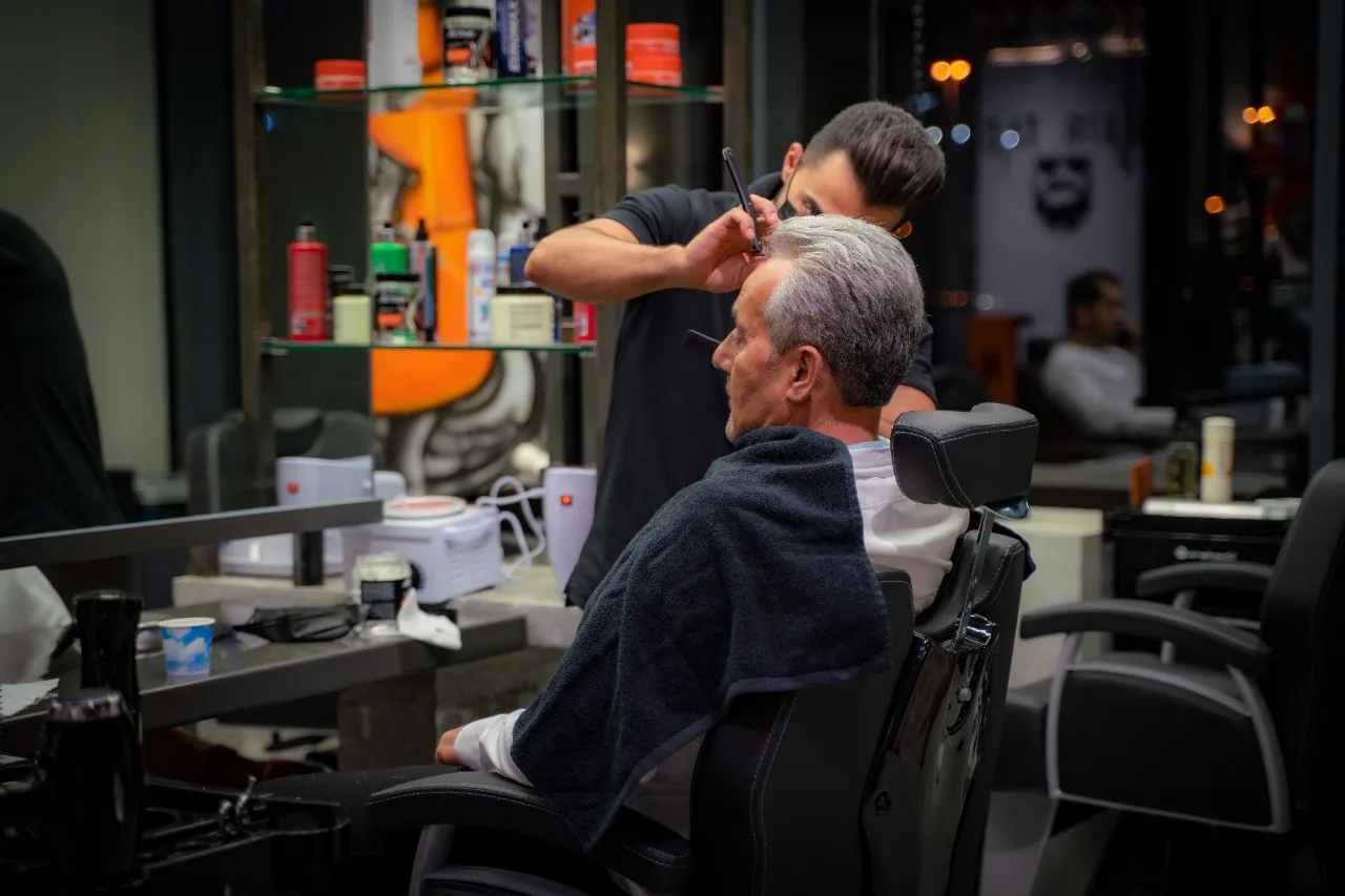 Barber giving a precise haircut to a client at Hair Tag