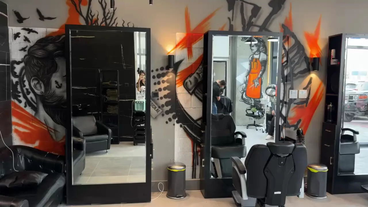 Mirror stations framed by orange street-art murals at Hair Tag