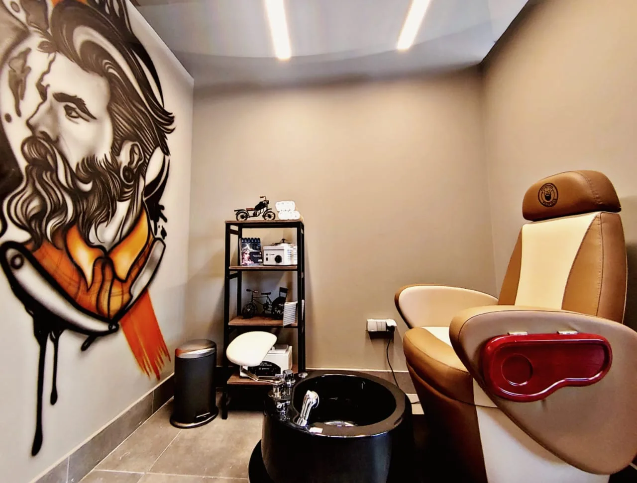 Private grooming room with a hand-painted bearded mural