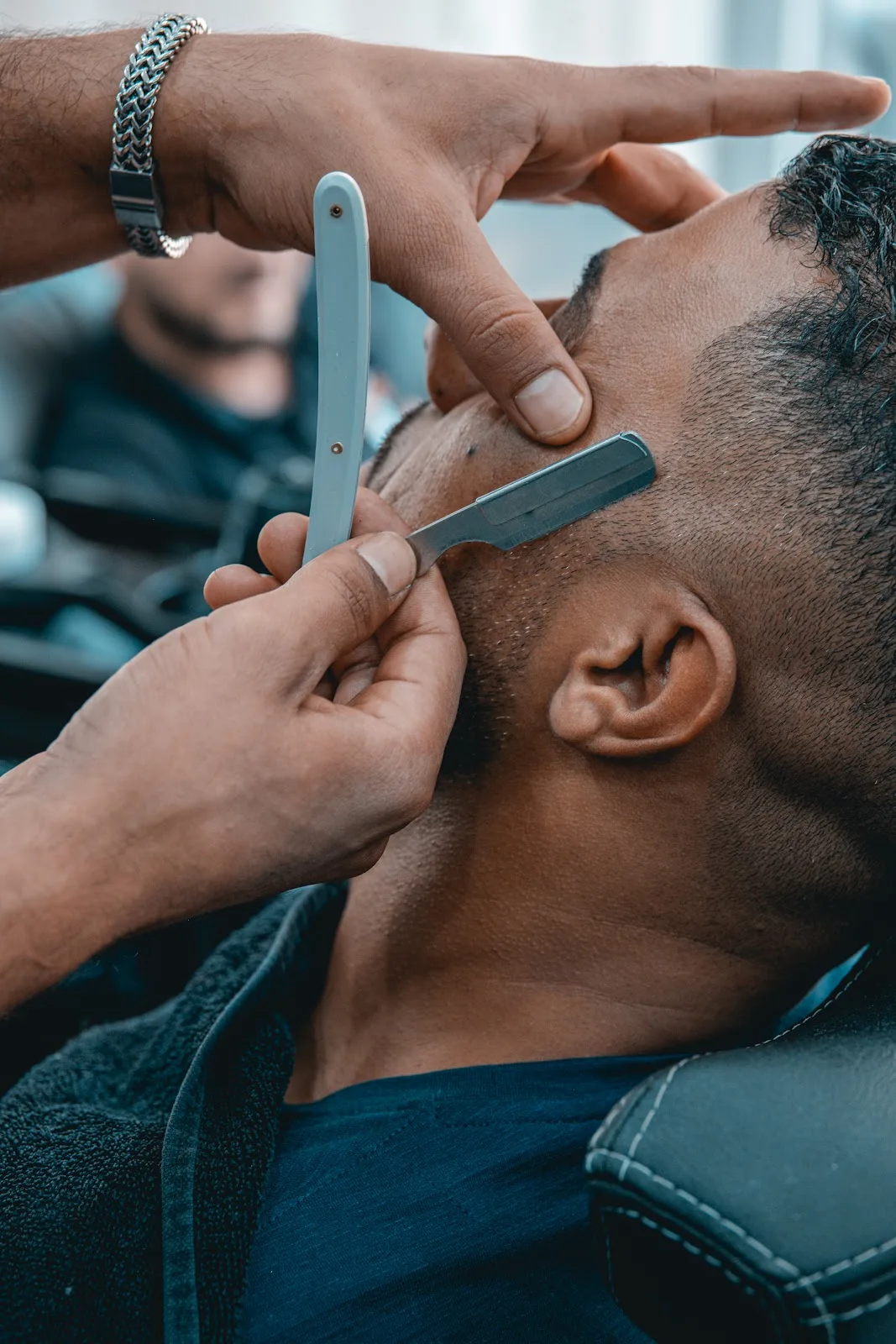 Straight-razor shave being performed on a client