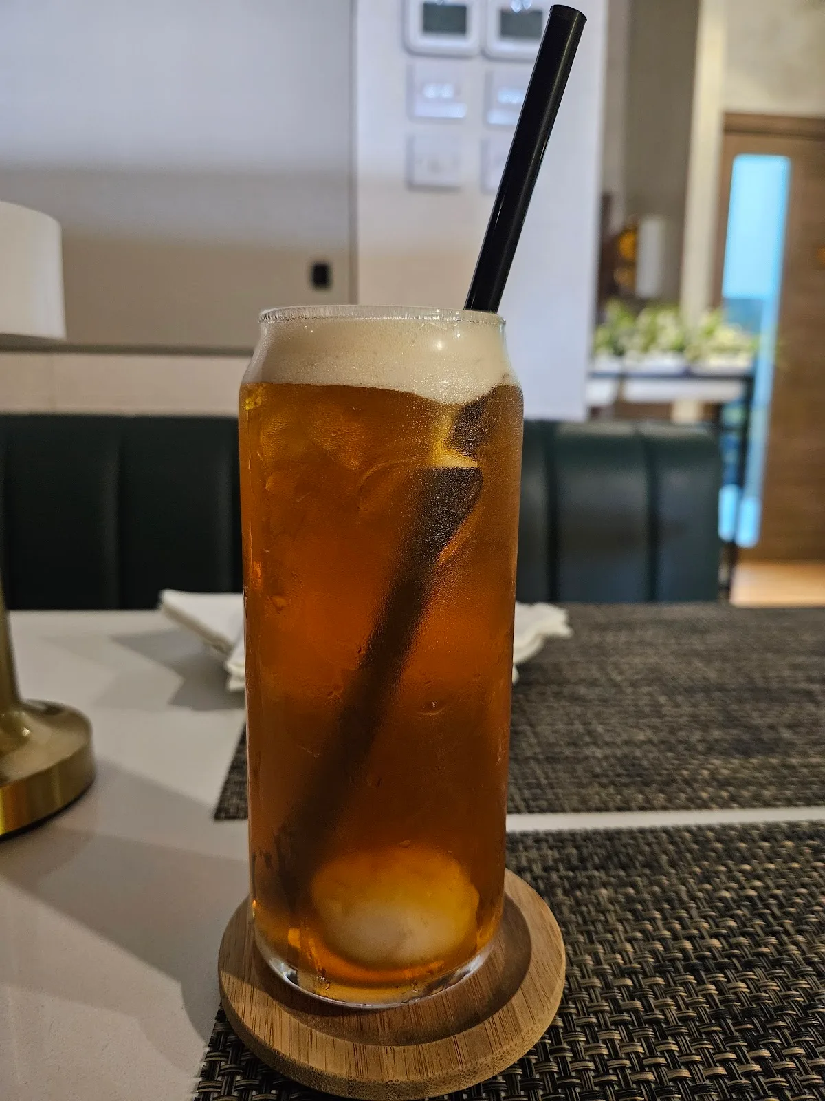 Iced tea served on a wooden coaster