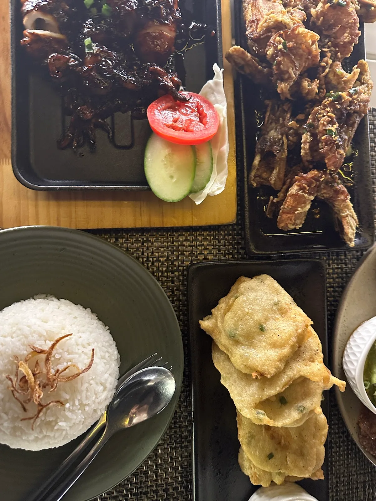 Overhead view of grilled meats and fried sides