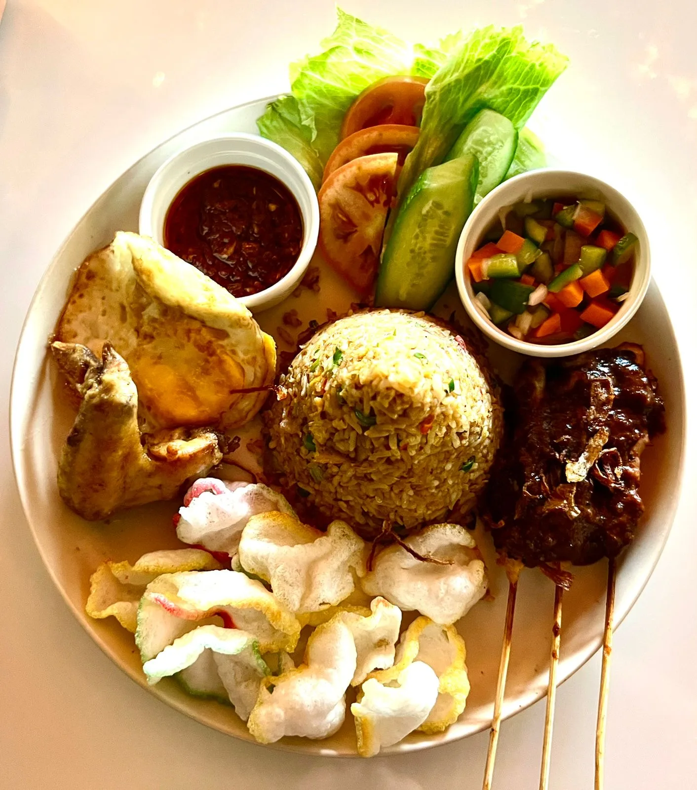 Nasi goreng platter with chicken, satay and prawn crackers