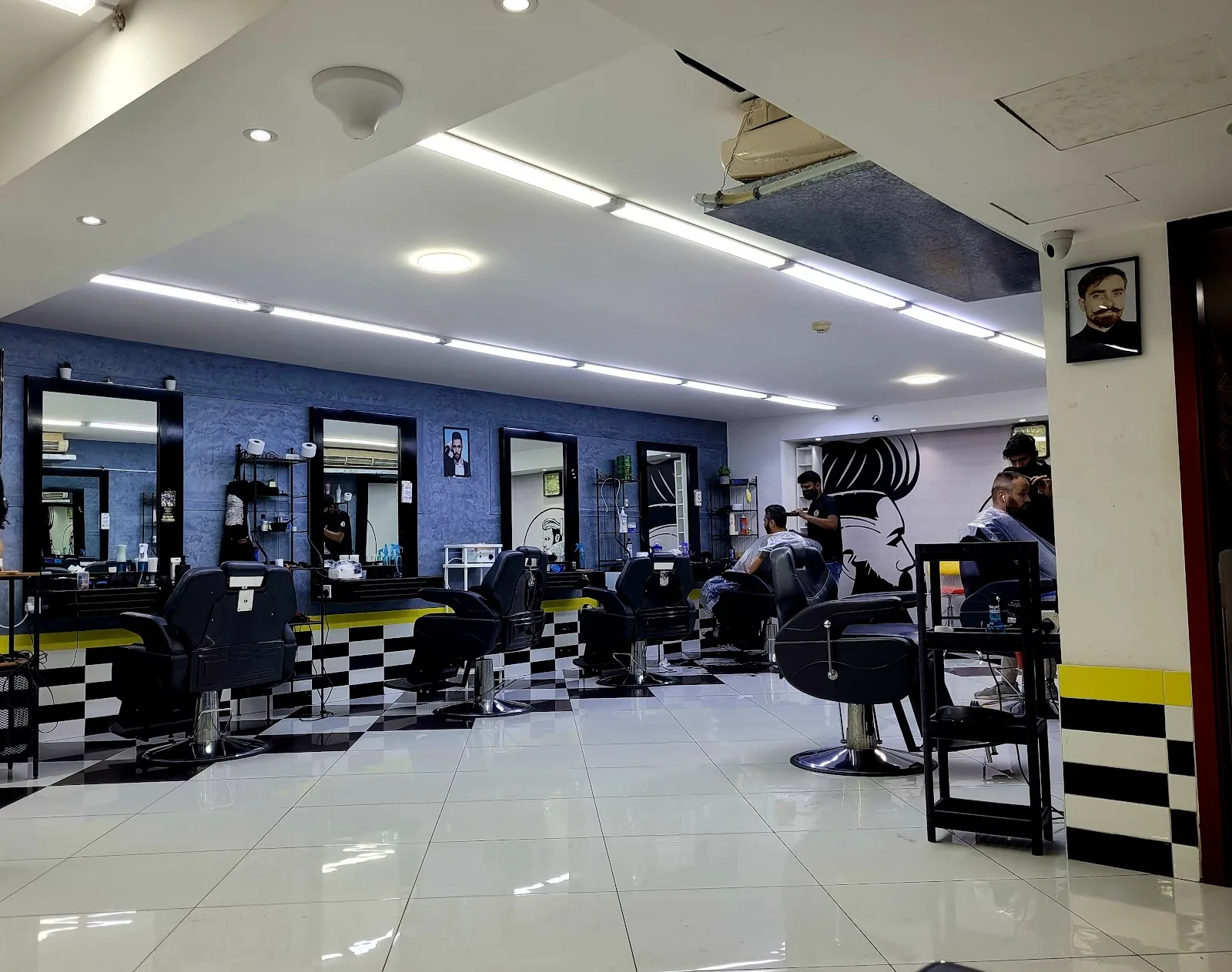 Inside BABA Gents Salon — barber chairs along a checkered-tile wall