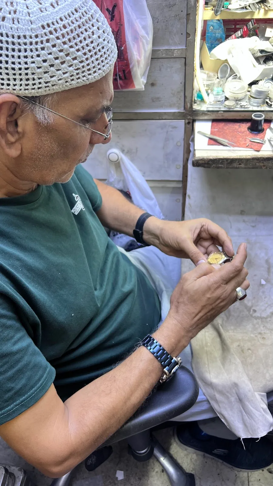 Close work fitting parts to a gold-tone wristwatch