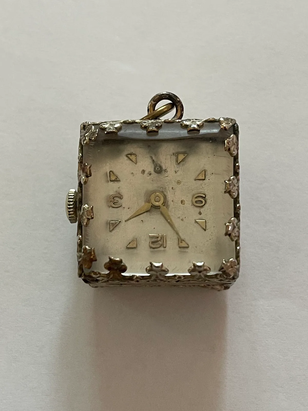 A vintage square pendant wristwatch with decorative case