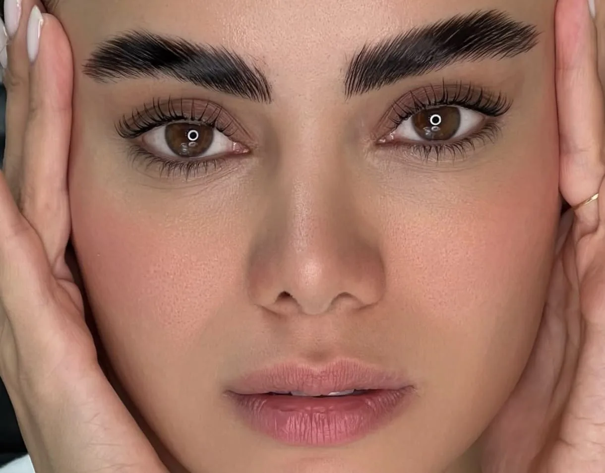 Close-up of groomed brows and lifted lashes after a brow and lash treatment