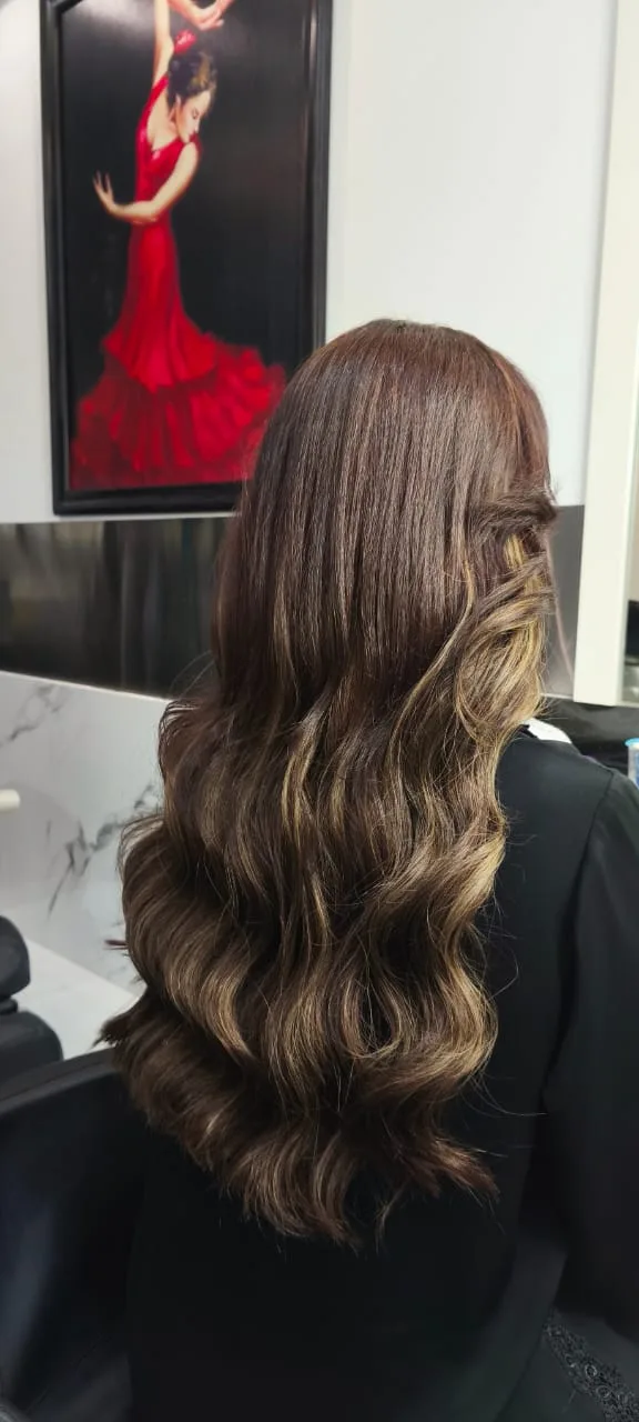 Brunette hair with soft balayage waves coloured at the salon