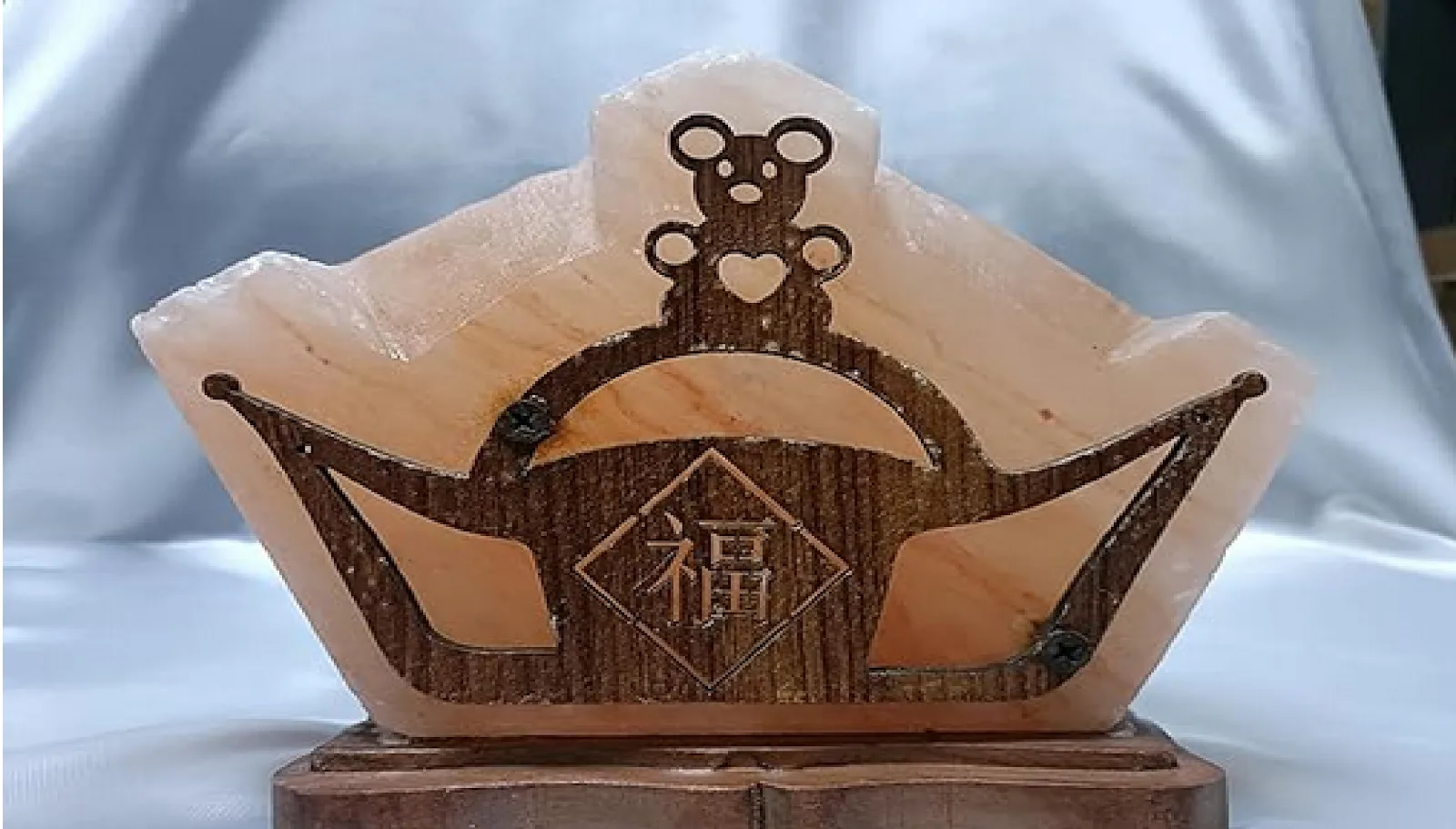 Himalayan salt lamp with a carved wooden teddy bear design