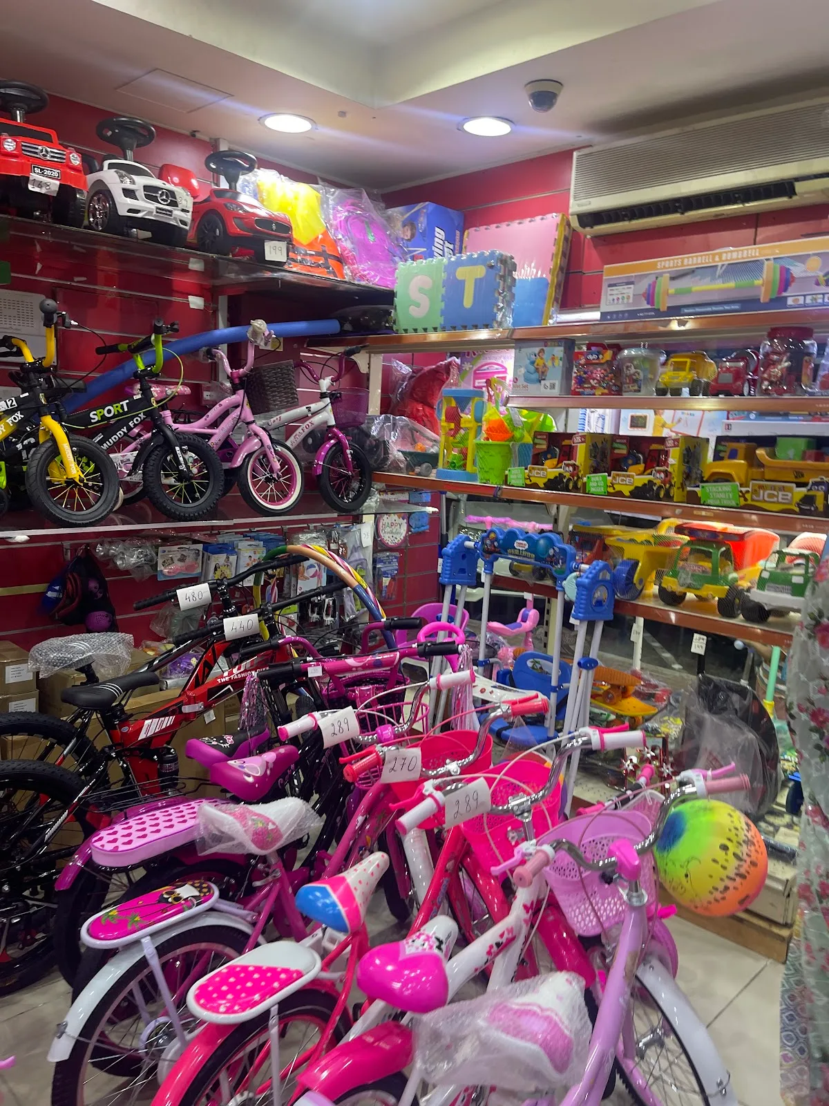 Rows of children's bikes and scooters on display in the shop