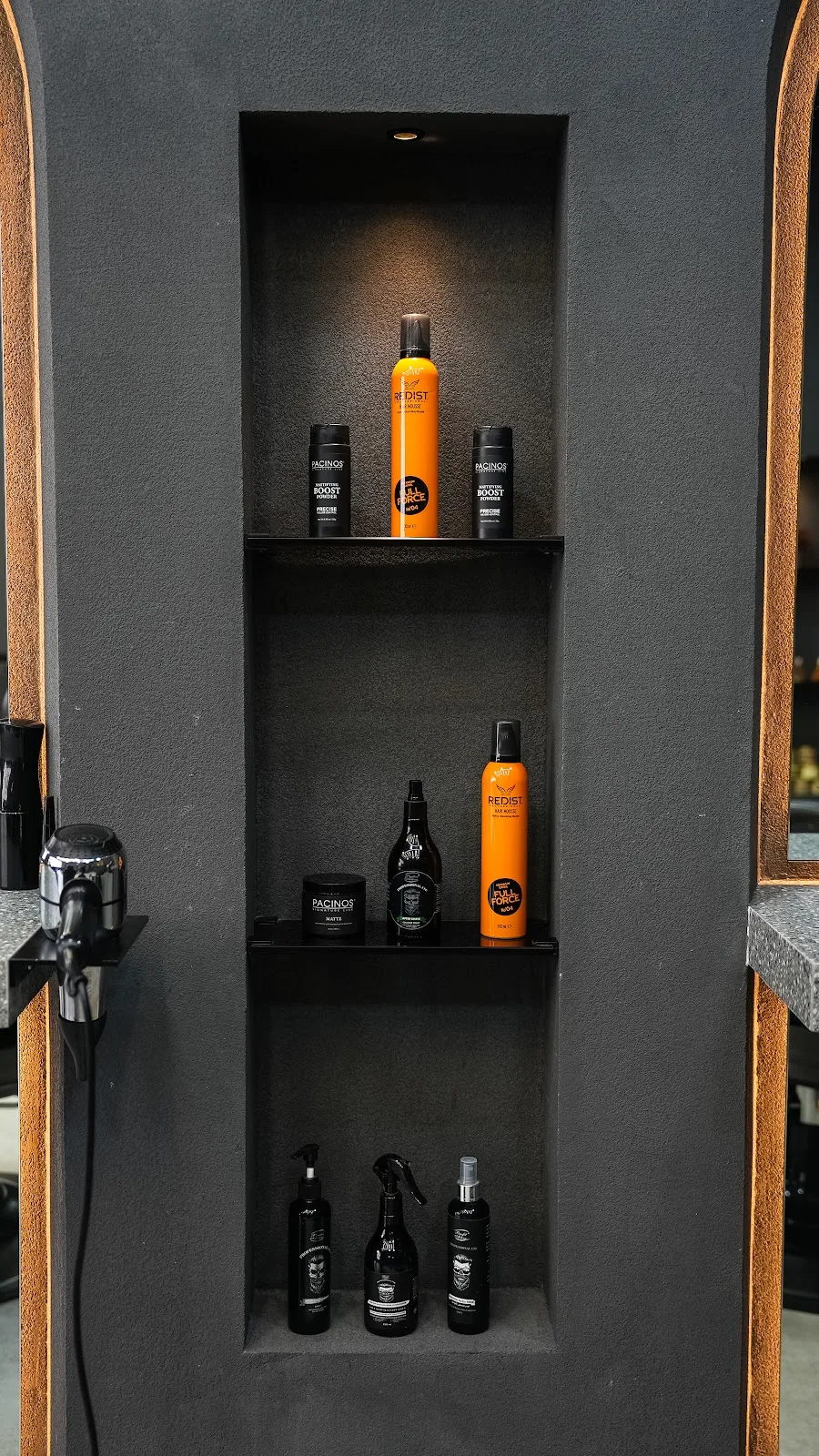 Men's grooming products displayed in a gold-lit niche
