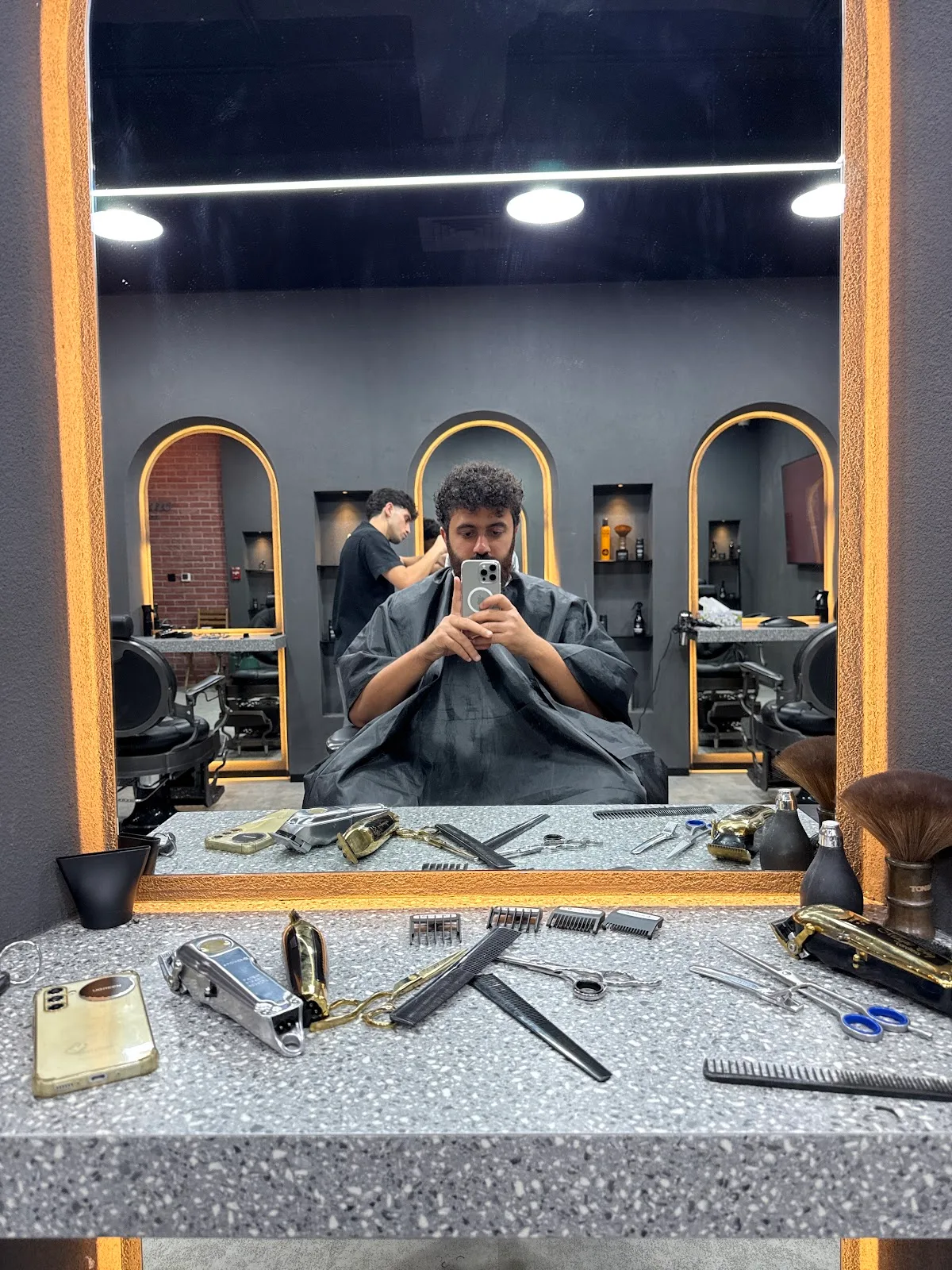 Barber station with mirror, tools and a client in the chair