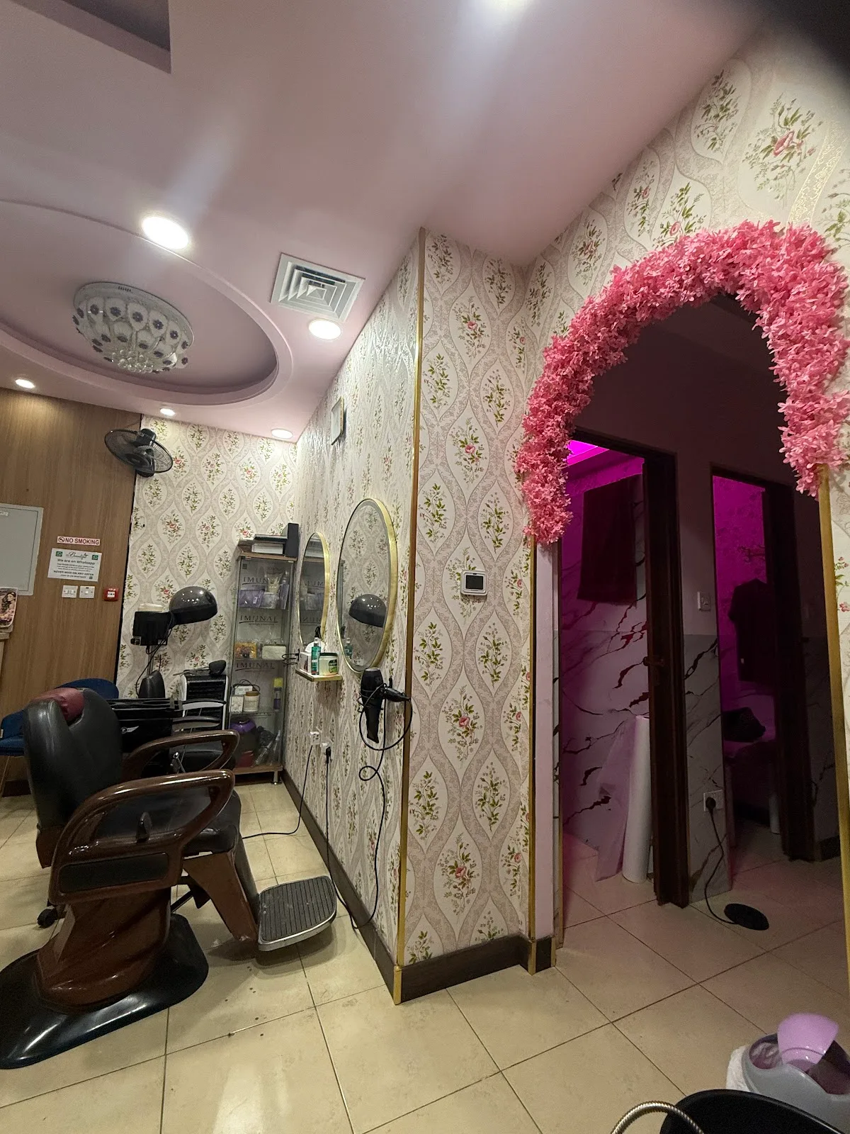 Interior of Runway Glam Ladies Salon showing styling stations and a floral entrance arch