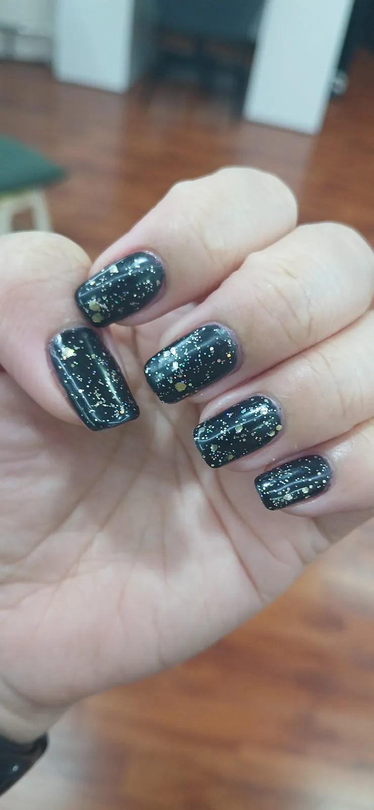 Dark nails with gold glitter finish