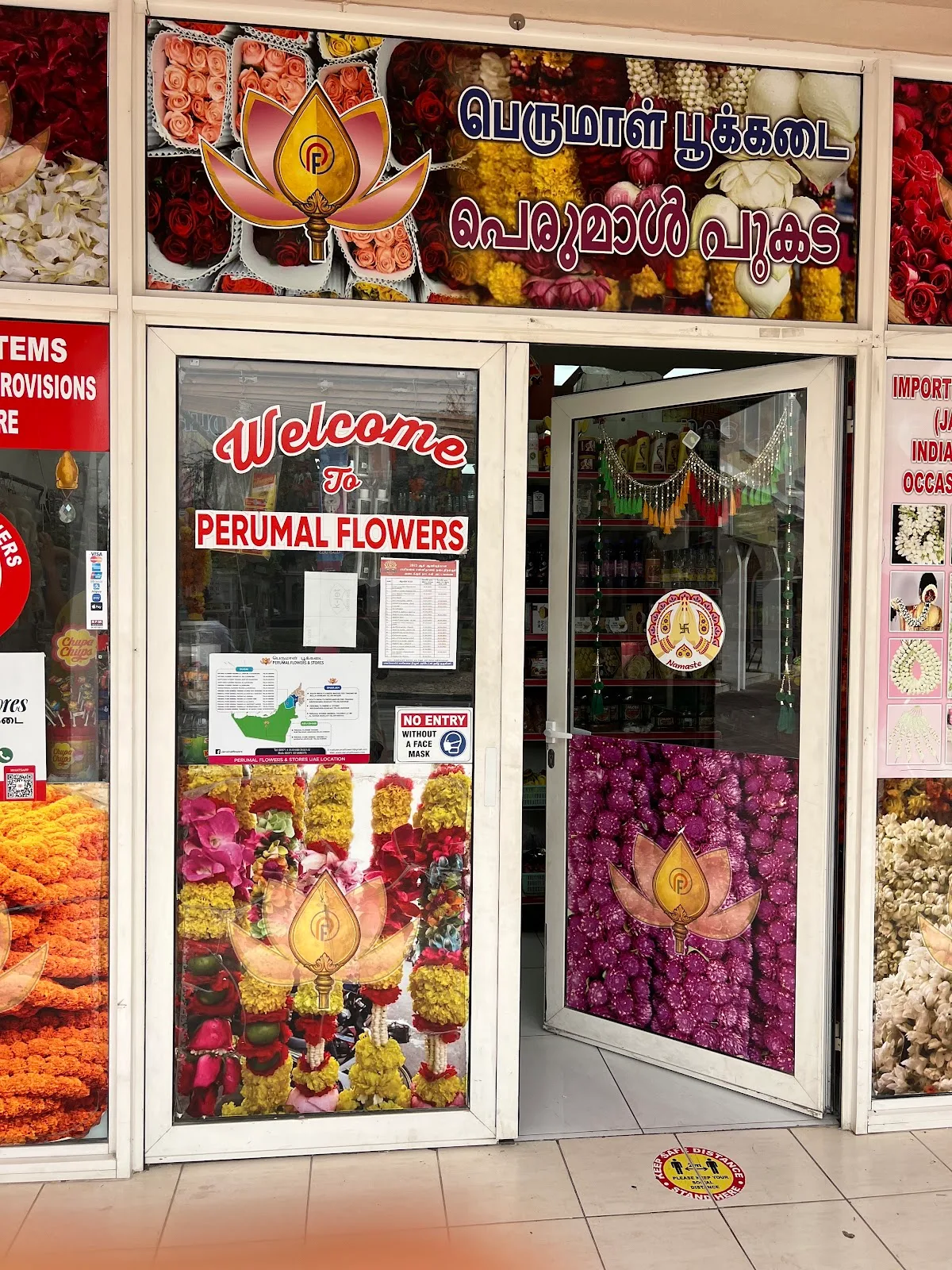 Welcome to Perumal Flowers — the store entrance decorated with floral posters