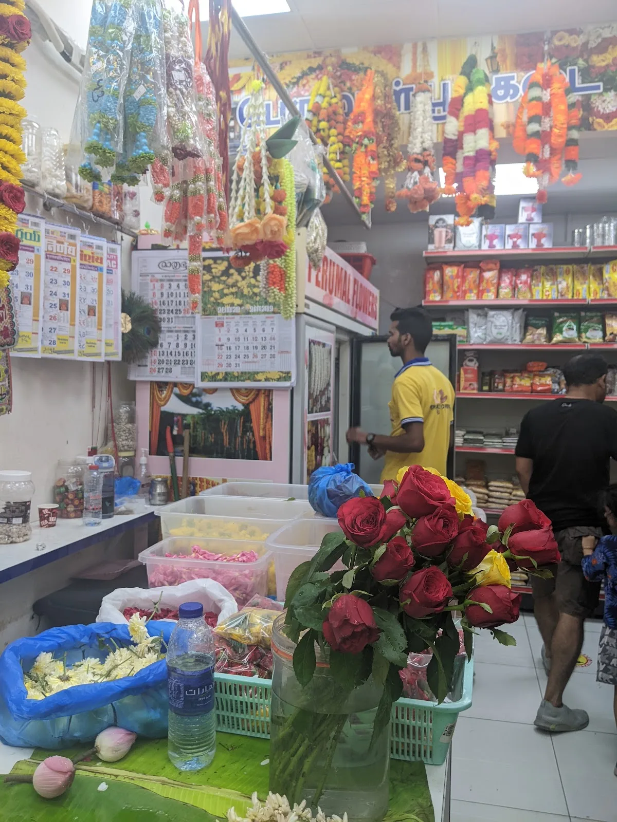 Red and yellow roses on the counter inside Perumal Flowers