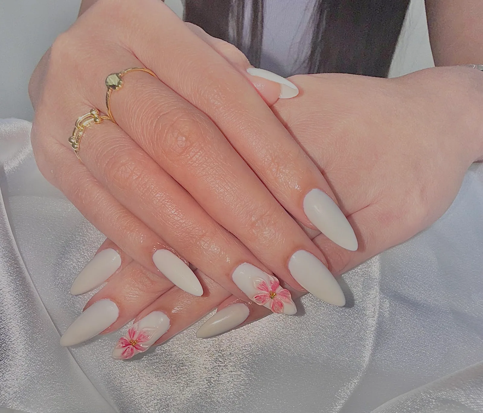 Almond nails in milky white with pink floral accent