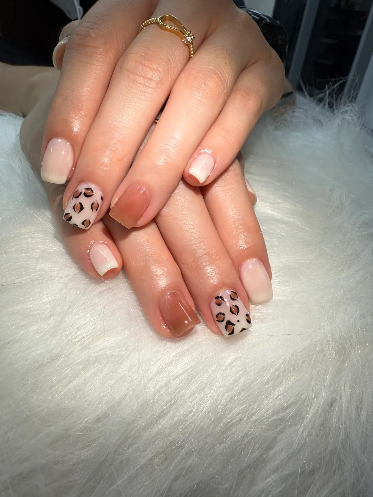 Neutral and brown nails with leopard-print accent