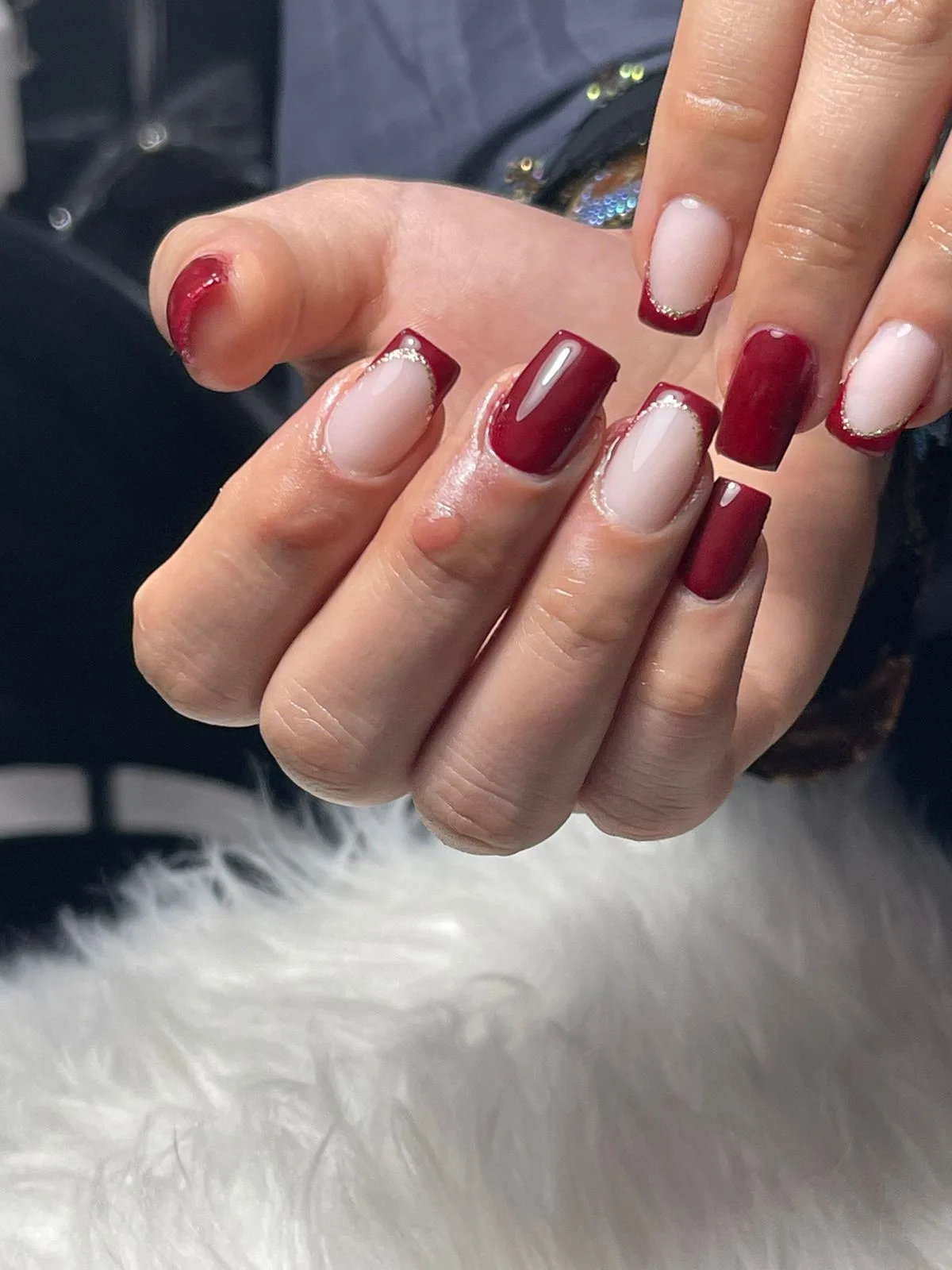 Burgundy nails with reverse French and gold line