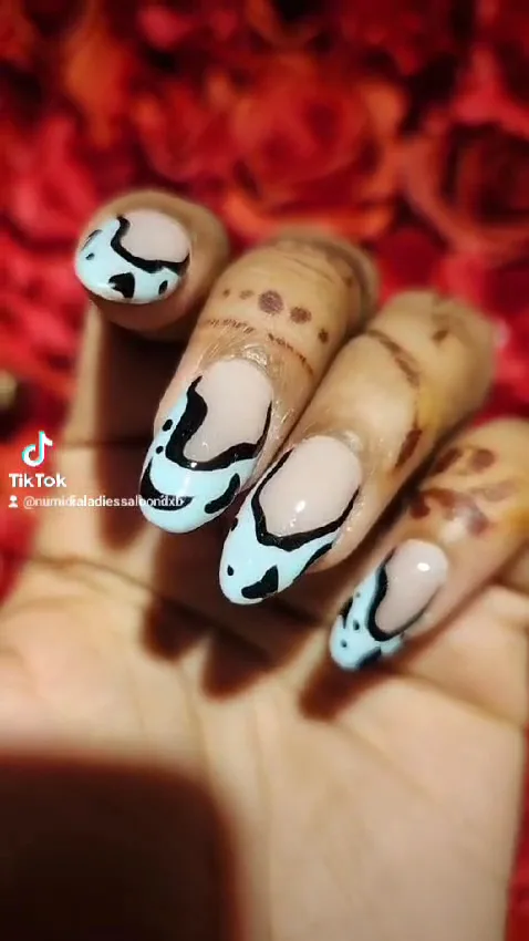 Nude nails with light blue and black abstract art