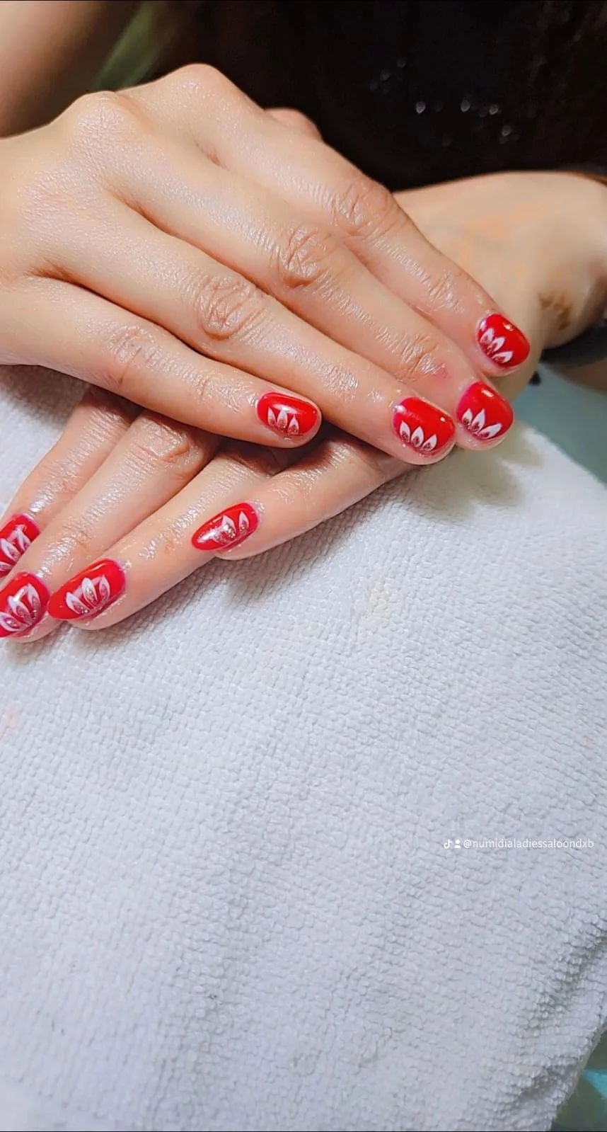 Red nails with white floral design