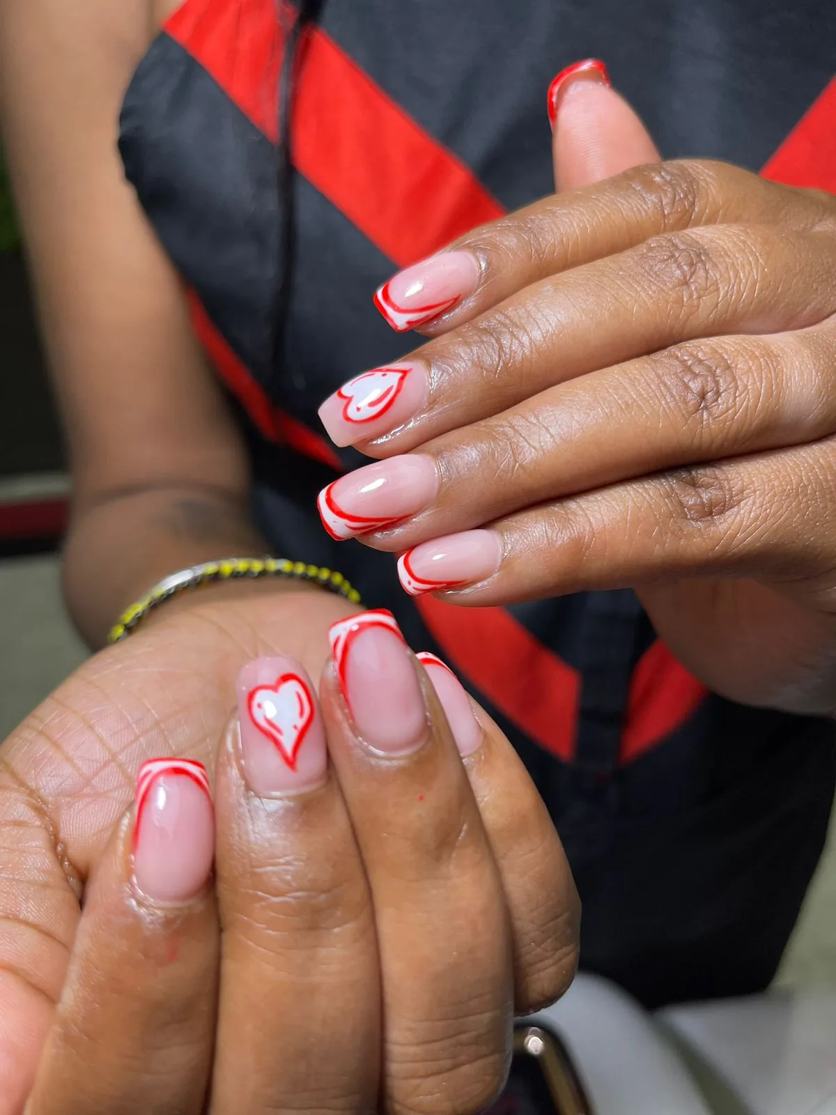 French nails with red outlines and heart art