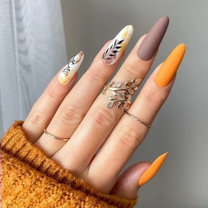 Autumn-toned almond nails with leaf art
