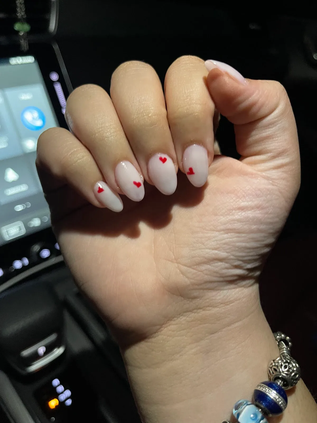 Milky nails with hand-painted red heart accents