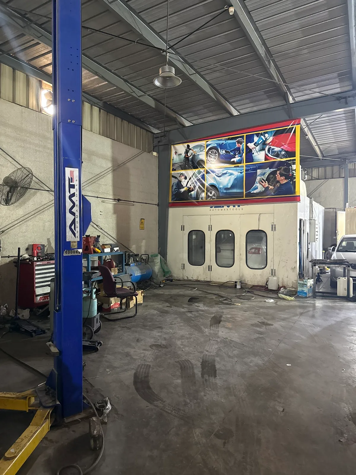 Interior of Bindarwash Garage showing a two-post lift and an in-house spray booth