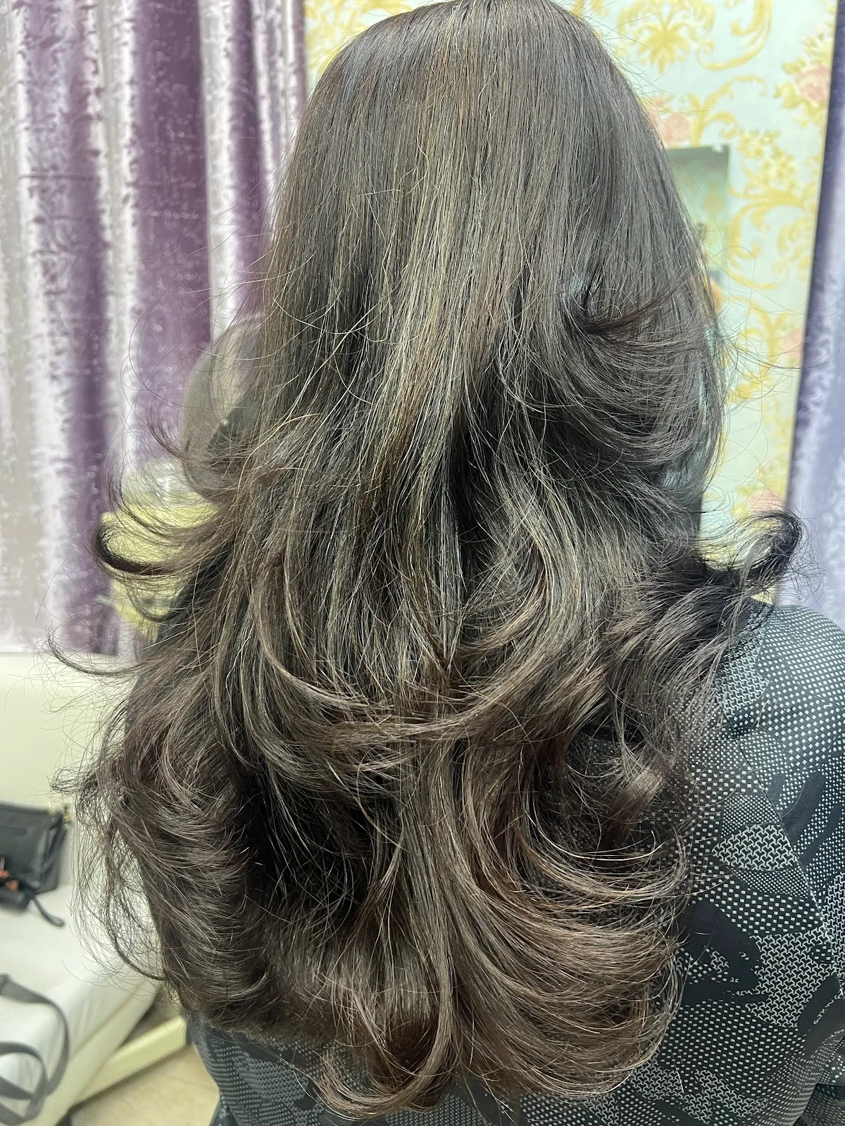 Layered cut and bouncy blow-dry styled at Falak Ladies Salon