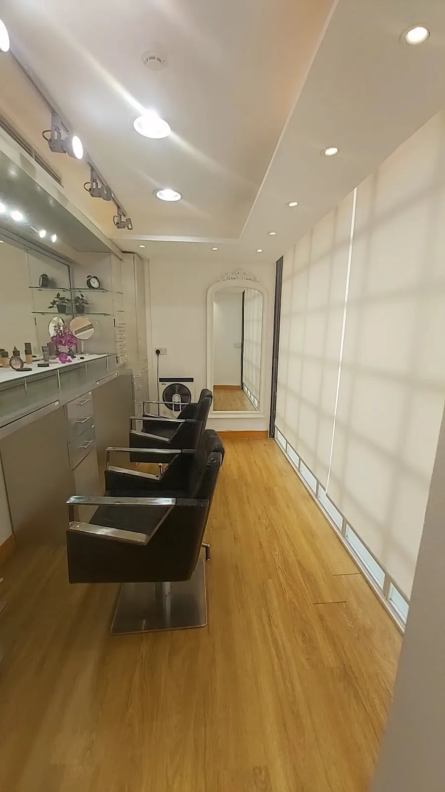 Hair styling chairs and mirror at Aroushi Beauty Salon