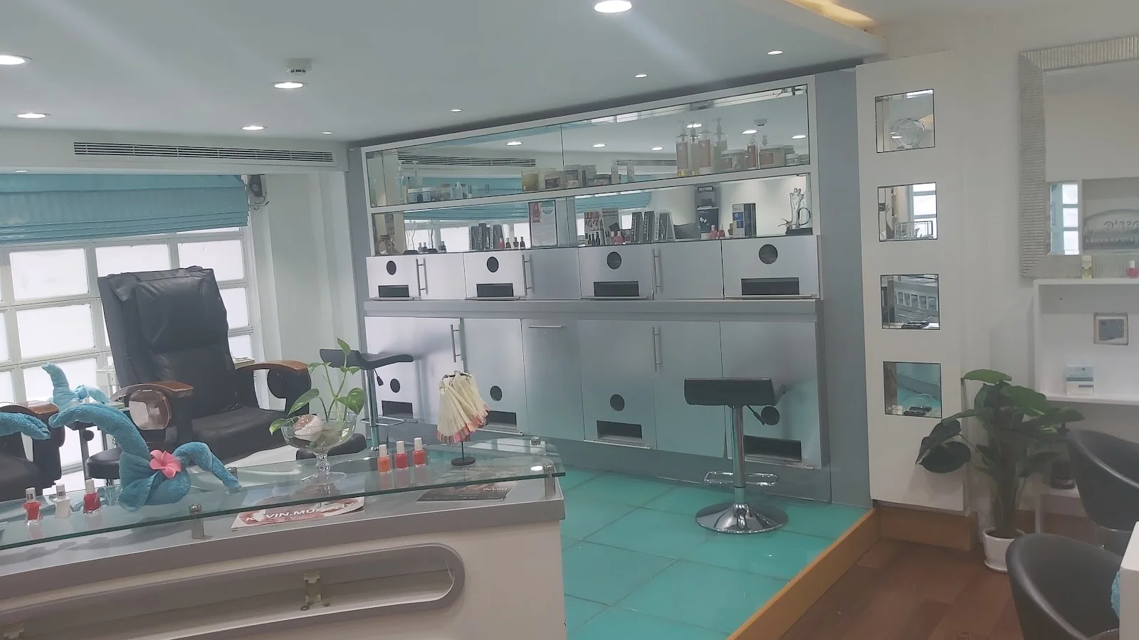 Nail and retail interior with teal floor at Aroushi Beauty Salon