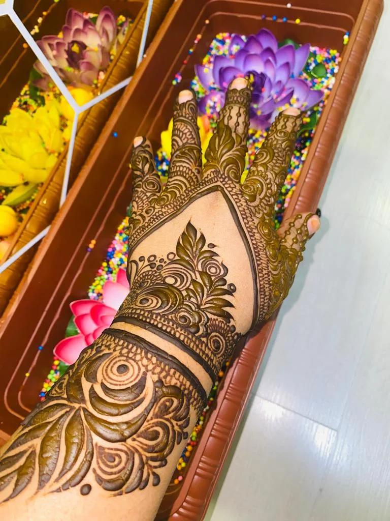 Detailed bridal henna design on a hand
