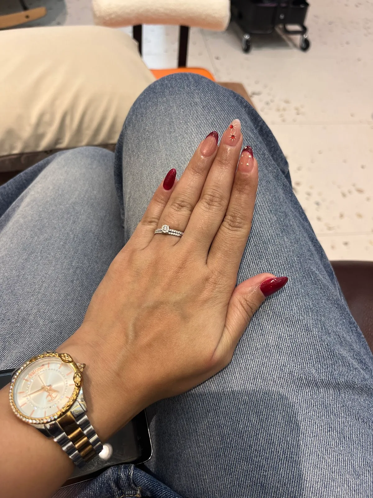 Glossy red French-tip manicure with fine detailing