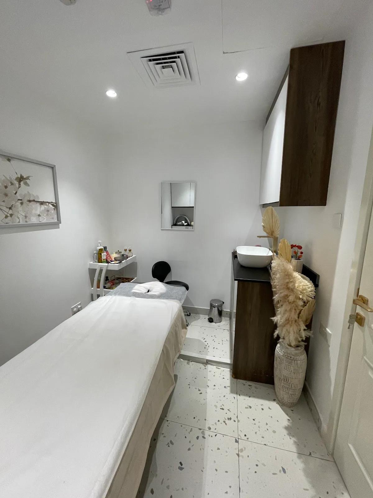 Private treatment room with soft lighting and timber accents