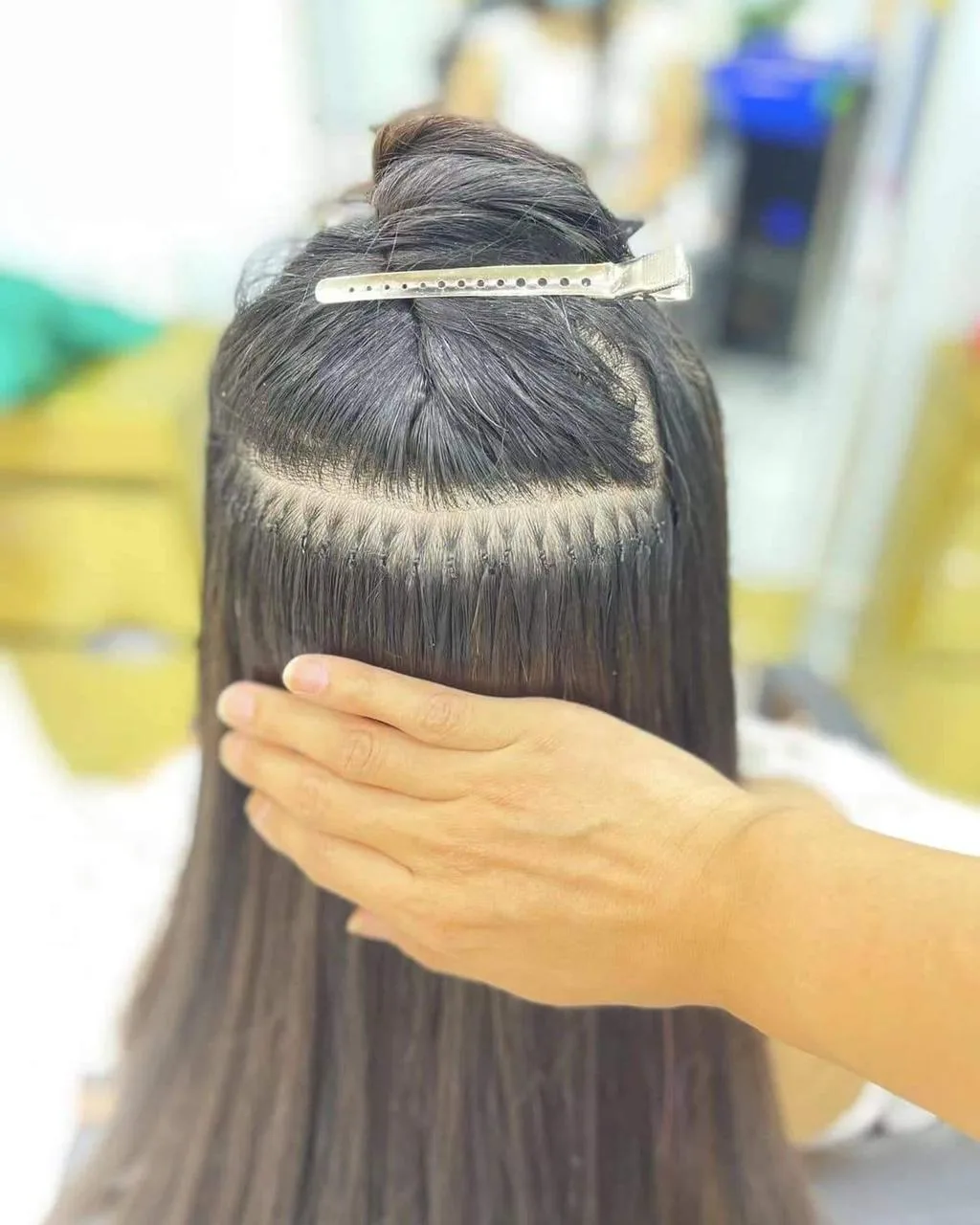 Micro-ring hair extensions being fitted