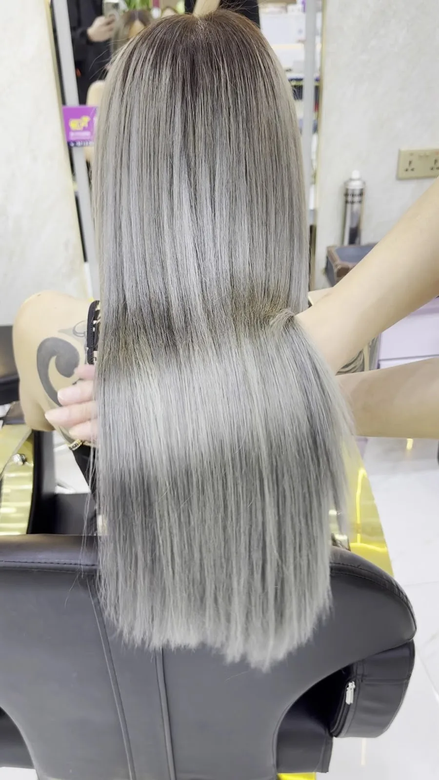 Glossy ash-silver balayage styled at the salon