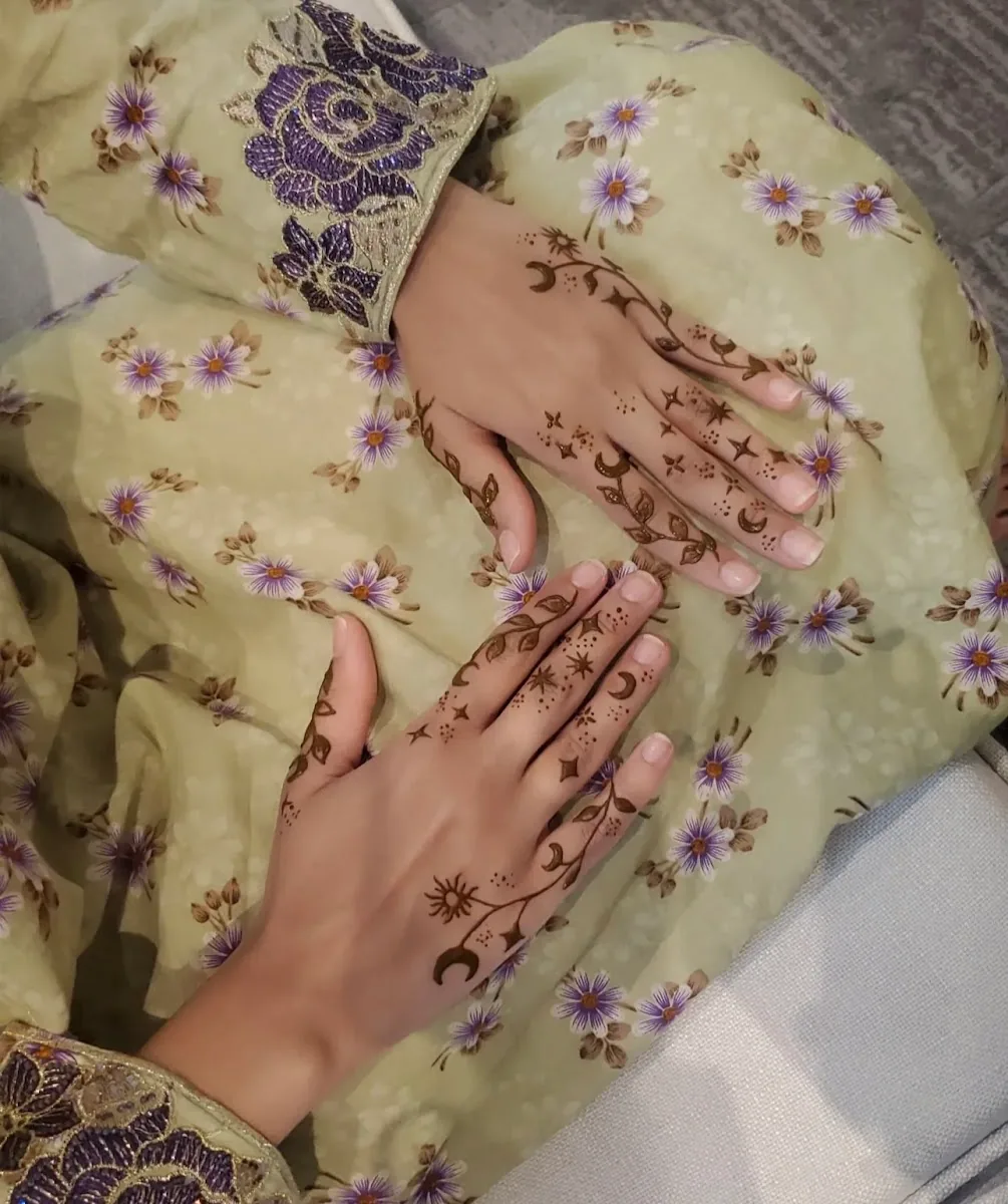Delicate floral henna across the hands