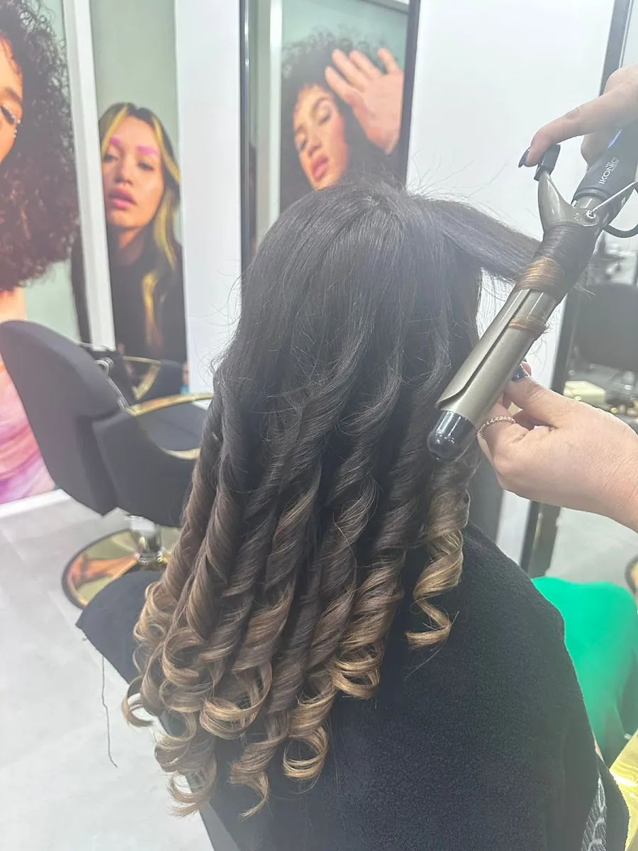 Hair being curled into ombré waves