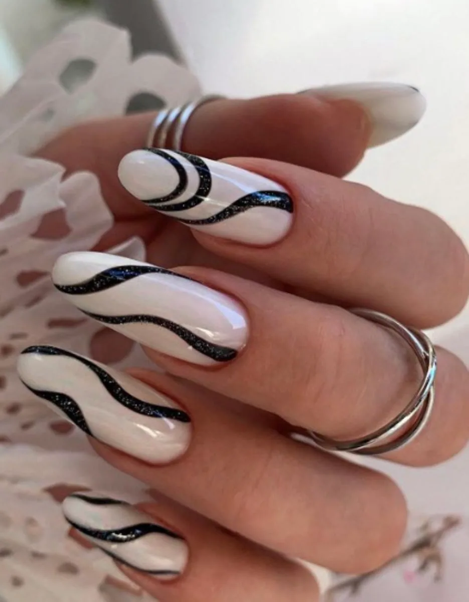 White nails with black swirl art