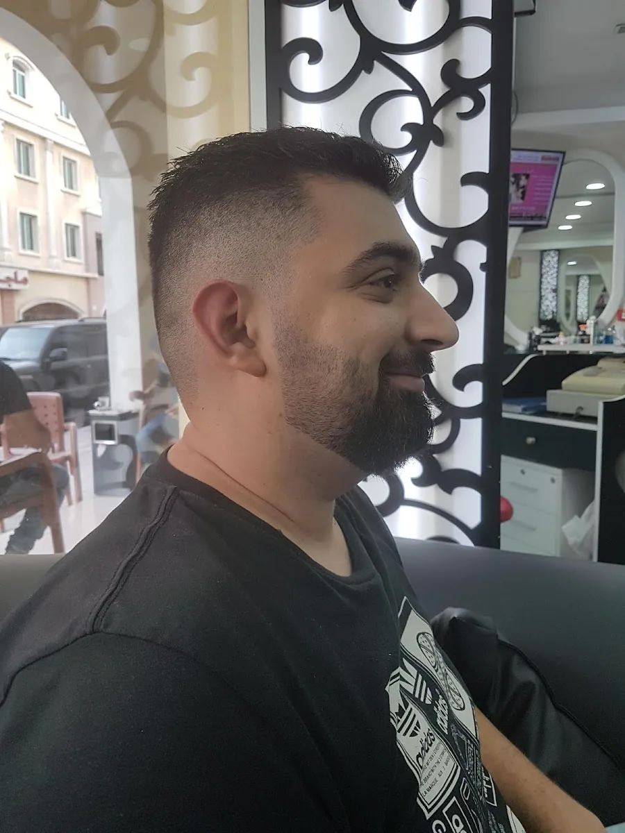 Side profile of a skin fade with a sculpted full beard