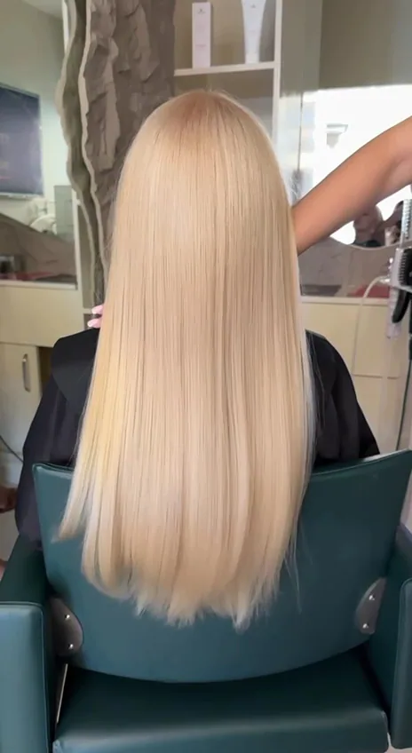 Long, glossy blonde blow-dry styled at the salon