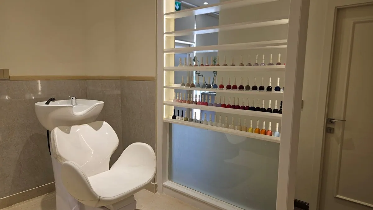 Wall display of nail polish colours beside a styling chair