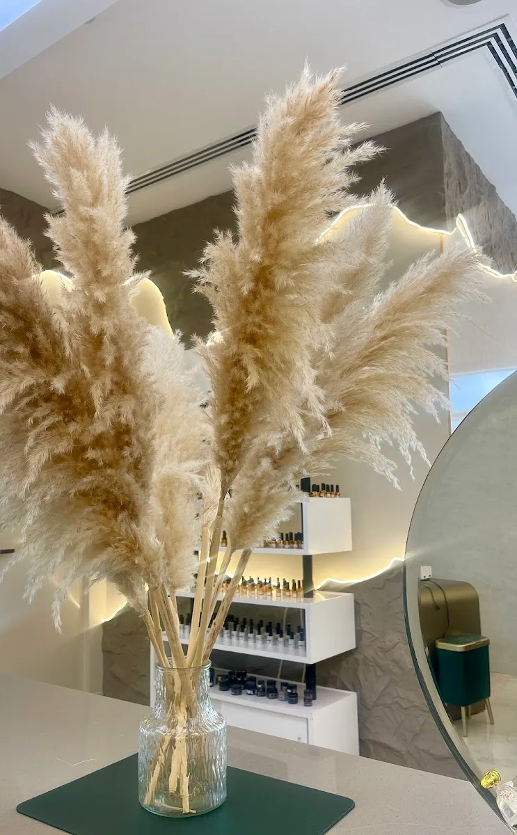 Pampas grass arrangement against textured stone wall