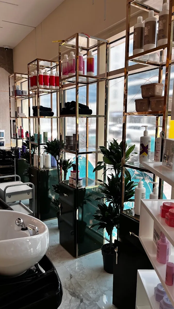Brass and glass shelving with professional haircare products
